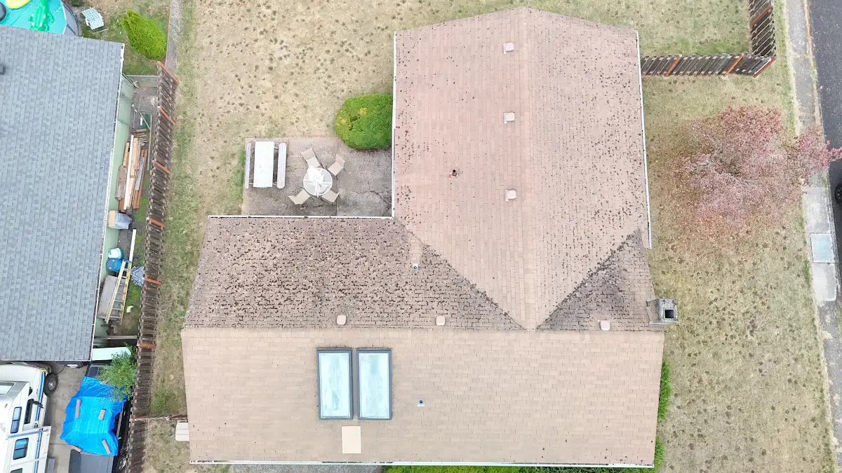 Aerial view of a 19-year-old roof with an old solar water heater on a home in Aldercrest, Milwaukie, OR
