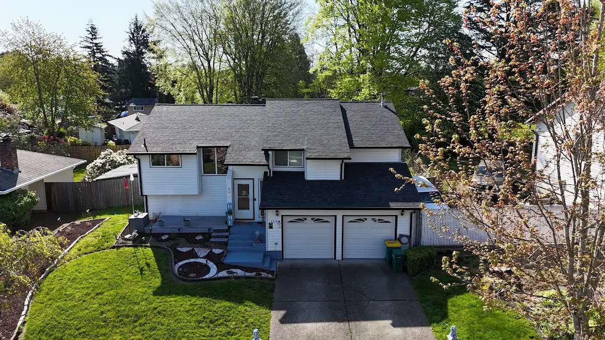 Finished Malarkey Vista roof and new black gutters on a split-level home in Troutdale, OR